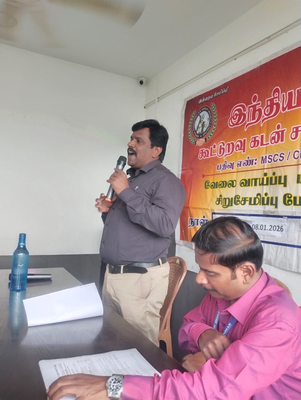 ICCSL official addressing members at a savings awareness meeting